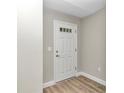 Front entry with wood-look flooring and a white door at 25 Locust Loop Ln, Ocala, FL 34472