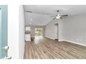 Open living area with vinyl plank flooring and neutral walls at 25 Locust Loop Ln, Ocala, FL 34472