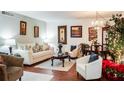 Spacious living room with hardwood floors, comfy seating, and a dining area at 293 Scottsdale Sq # 293, Winter Park, FL 32792