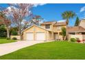 Tan two-story townhouse with a two-car garage and manicured lawn at 545 Brown Pelican Dr, Daytona Beach, FL 32119