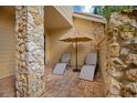 Relaxing patio with lounge chairs and a thatched umbrella at 545 Brown Pelican Dr, Daytona Beach, FL 32119