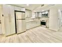 Modern kitchen with stainless steel appliances and light gray cabinets at 6668 Pompeii Rd, Orlando, FL 32822