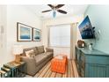 Cozy living room with a sofa, TV, and accent pieces at 8019 Knee Deep Rd, Kissimmee, FL 34747