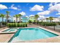 Community pool and spa with surrounding landscaping at 8019 Knee Deep Rd, Kissimmee, FL 34747