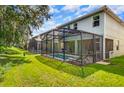 Home with fenced-in pool and screened patio area at 8848 Candy Palm Rd, Kissimmee, FL 34747