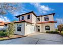 Two-story house with tile roof, white exterior, and a two-car garage at 133 Summer Place Loop, Clermont, FL 34714