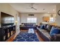 Spacious living room with leather sofas, wood floors, and large TV at 133 Summer Place Loop, Clermont, FL 34714