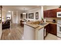 Kitchen features granite countertops and dark wood cabinets at 1351 Tuscan Ter # 8401, Davenport, FL 33896