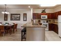 Well-equipped kitchen with granite counters and wooden cabinets at 1351 Tuscan Ter # 8401, Davenport, FL 33896