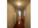 Hallway with light walls and tiled floor leading to archway at 13560 Turtle Marsh Loop # 319, Orlando, FL 32837