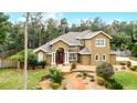 Two-story house with landscaped yard and walkway at 1437 Pecos Dr, Ormond Beach, FL 32174