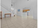 Living room with high ceilings, tile floors, and a view of the kitchen at 204 Paloma Dr, Davenport, FL 33837
