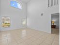 Spacious living room with high ceilings and tile floors at 204 Paloma Dr, Davenport, FL 33837