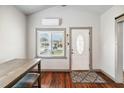 Inviting entryway with a decorative door, window, and hardwood floors at 211 Indiana Ave, St Cloud, FL 34769