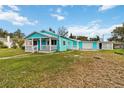 Inviting blue one story house boasting a spacious yard and covered porch at 211 Indiana Ave, St Cloud, FL 34769