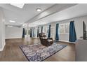 Bright basement recreation room featuring a comfortable recliner and large windows at 223 Royal Oaks Cir, Longwood, FL 32779