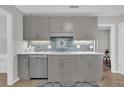 Modern kitchen with gray cabinets and stainless steel appliances at 223 Royal Oaks Cir, Longwood, FL 32779