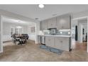 Bright kitchen featuring stainless steel appliances, tile backsplash, and a seamless transition into the dining area at 223 Royal Oaks Cir, Longwood, FL 32779