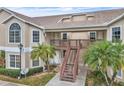 Two-story condo building with stairs and balconies at 2321 Prime Cir # B, Kissimmee, FL 34746