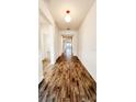 Long hallway with wood-look tile floors at 273 Ancona Ave, Debary, FL 32713