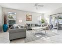 Spacious living room with gray sofas, a coffee table, and large windows at 305 Therese St, Davenport, FL 33897
