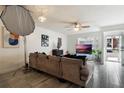 Spacious living room with large TV and sliding glass doors leading to exterior at 5437 Lake Margaret Dr # C, Orlando, FL 32812