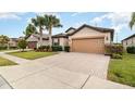 Two-story house with a two-car garage and a manicured lawn at 672 Cordoba Dr, Davenport, FL 33837
