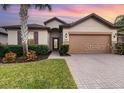 Well-maintained house with a two-car garage and attractive landscaping at 672 Cordoba Dr, Davenport, FL 33837
