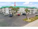 Front view of condo building, showing parking and landscaping at 815 Ocean Shore Blvd # U9A, Ormond Beach, FL 32176