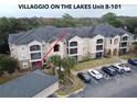 Aerial view of condo building, showing unit location and parking at 940 Village Trl # 8-101, Port Orange, FL 32127
