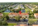 Aerial view showing townhome community near a lake at 1065 Park Ridge Cir, Kissimmee, FL 34746