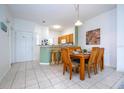 Dining area with wood table and chairs, adjacent to kitchen at 1065 Park Ridge Cir, Kissimmee, FL 34746