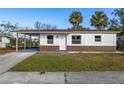 Newly renovated house featuring a carport and well-maintained lawn at 128 Academy Ave, Sanford, FL 32771