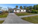 Newly renovated house with a carport and a spacious front yard at 128 Academy Ave, Sanford, FL 32771