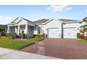 Brick paver driveway and two car garage at 16719 Sanctuary Dr, Winter Garden, FL 34787