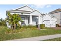 Two-story house with palm trees and landscaping at 16719 Sanctuary Dr, Winter Garden, FL 34787