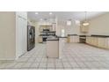Spacious kitchen with tile flooring, stainless steel appliances, and ample counter space for cooking at 2961 Cedar Glen Pl, Oviedo, FL 32765