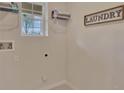 Bright laundry room with shelving and window at 308 Pelham Park Dr, Deland, FL 32720