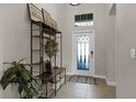 Inviting entryway with tiled floors and a stylish storage unit at 3649 Corsica Ln, Clermont, FL 34711