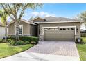 One story house with a two-car garage and landscaped front yard at 3649 Corsica Ln, Clermont, FL 34711