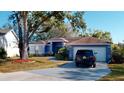 House exterior showcasing a driveway and landscaping at 3917 Derby Dr, Lakeland, FL 33809