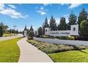Tuscawilla Crossings entrance sign with landscaping and a paved walkway at 394 Singing Tree Ln, Winter Springs, FL 32708