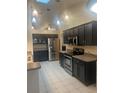 Modern kitchen with stainless steel appliances and dark cabinets at 4104 Bob White Ct, Saint Cloud, FL 34772