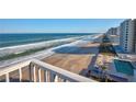 Aerial view showcases beach, ocean, and high-rise buildings at 5203 S Atlantic Ave # 815B, New Smyrna Beach, FL 32169