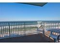 Breathtaking ocean view from balcony, featuring white chairs and railings at 5203 S Atlantic Ave # 815B, New Smyrna Beach, FL 32169