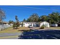 Single-story home with driveway, landscaping, and fenced yard at 547 Queens Mirror Cir, Casselberry, FL 32707