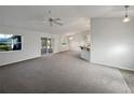 Spacious living room with neutral carpeting and lots of natural light at 7207 Summit Pl, Winter Haven, FL 33884