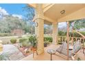 Covered porch with swing and view of the backyard at 8520 Sw 209Th Ct, Dunnellon, FL 34431
