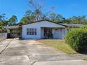 White brick ranch house with carport and a large yard at 1070 N Libby Ct, Daytona Beach, FL 32117