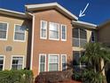 Condo building showcasing a tan facade and balconies at 12021 Villanova Dr # 111, Orlando, FL 32837